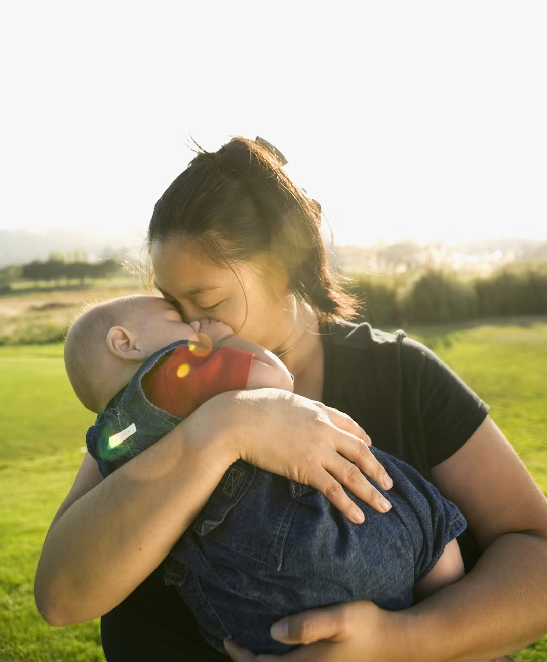 Woman holding her small child. Credit: Fotolia